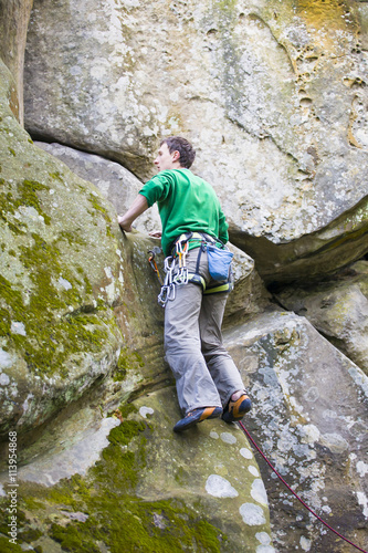 A rock climber climbs up the mountain. © zhukovvvlad