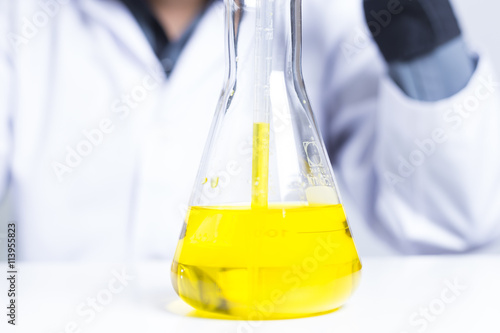 Sciencetist: Researcher Holding at a Liquid Solution on Isolated photo