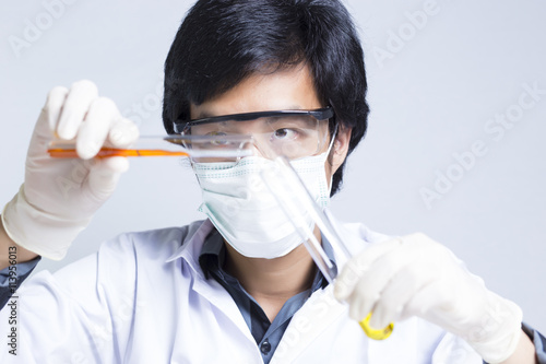 Sciencetist: Researcher Holding at a Liquid Solution on Isolated photo