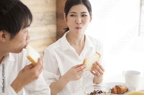Young couple is eating the bread