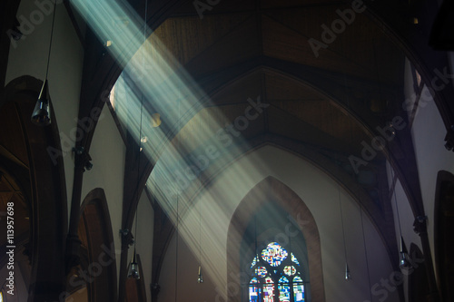 light shafts stream into church window
