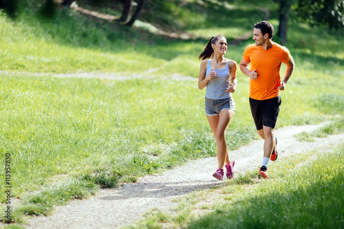 Fototapeta Naklejka Na Ścianę i Meble -  Beautiful couple jogging in nature
