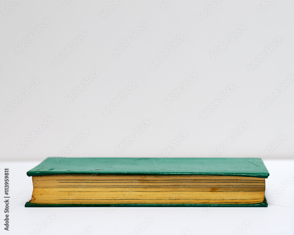 Hardback book on gray cloth. Back to school. Copy space Hardback book on gray cloth. Back to school. Copy space