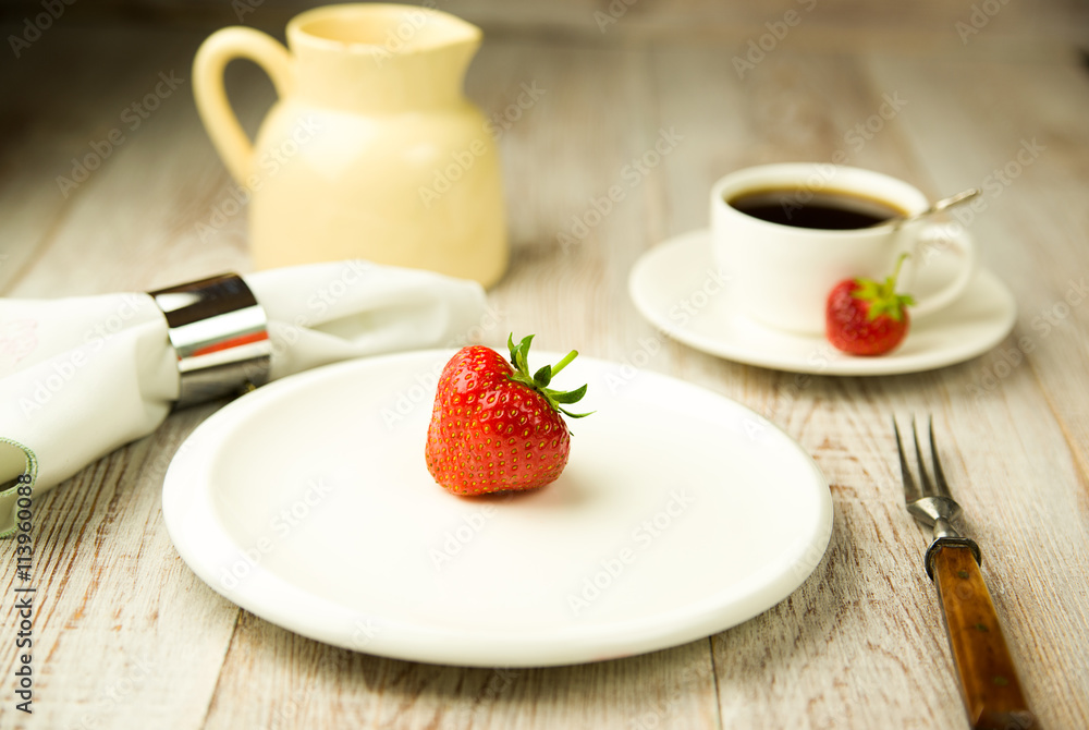 Ripe strawberry fruit on a white plate
