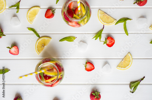 Fototapeta Naklejka Na Ścianę i Meble -  Fresh strawberry drink in bottle on wooden table