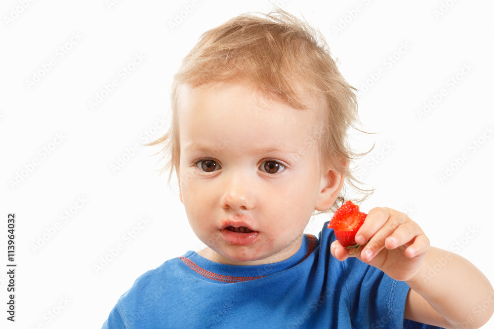 Portrait of a boy eating strawberries, on white background Portrait of a boy eating strawberries, on white background