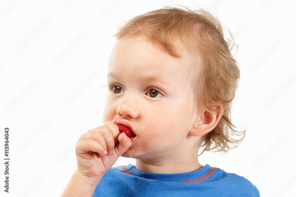 Portrait of a boy eating strawberries, on white background Portrait of a boy eating strawberries, on white background