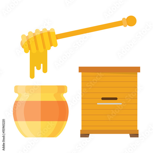 Glass jar of honey with wooden drizzler