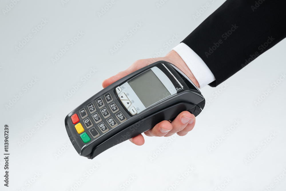 Hand of businessman holding payment terminal Hand of businessman holding payment terminal