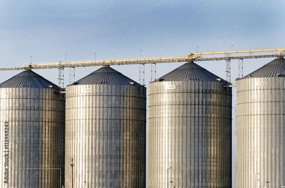 Exterior structure of new agriculture silo building. Steel grain silo towers.