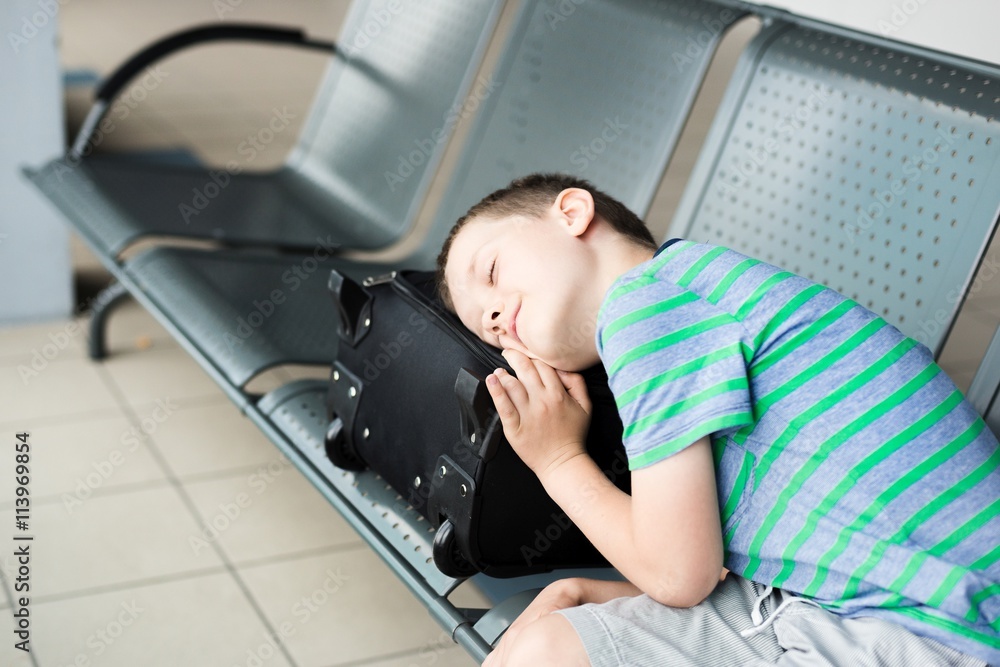Tired child boy sleeping at the airport Tired child boy sleeping at the airport
