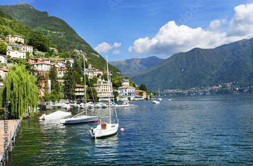 A beautiful day on lake Como in the romantic town Moltrasio. Villas, sailboat and jetty. Italy, Europe, sept. 2015