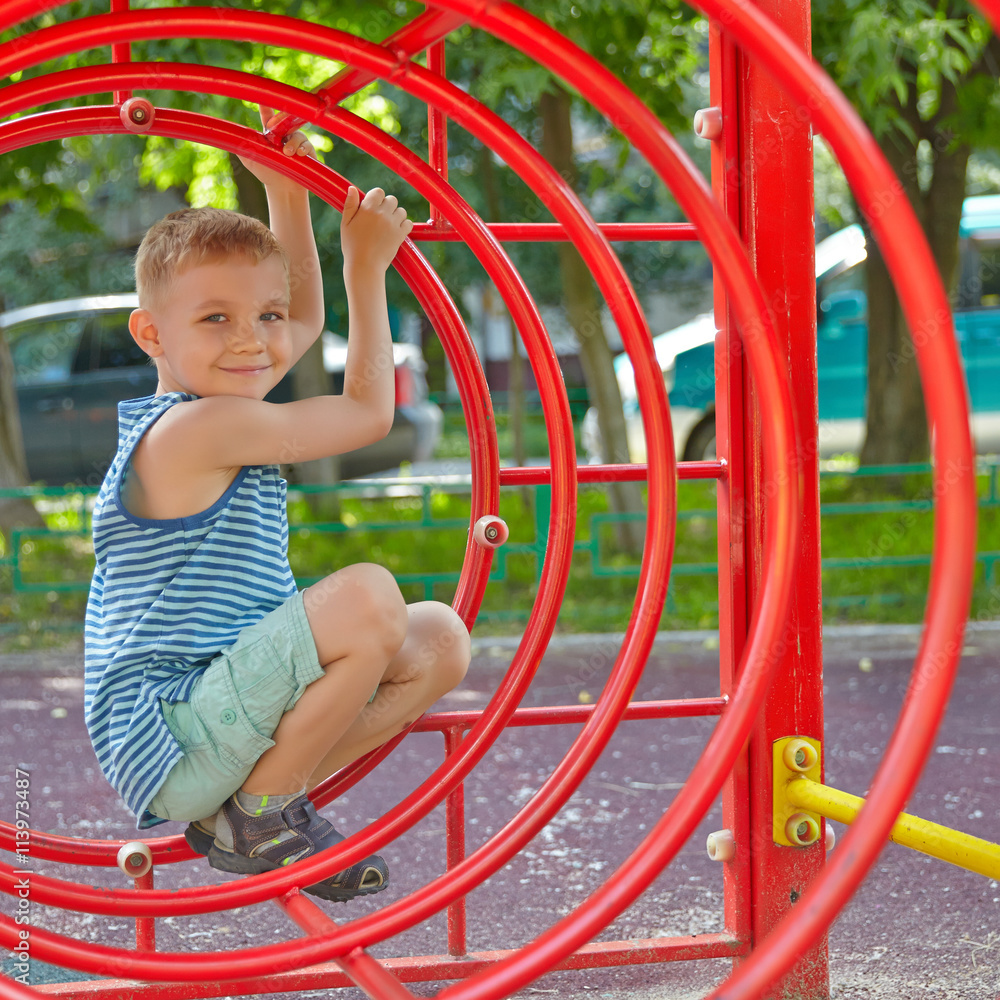 Cute boy playing in tunnel on playground Cute boy playing in tunnel on playground