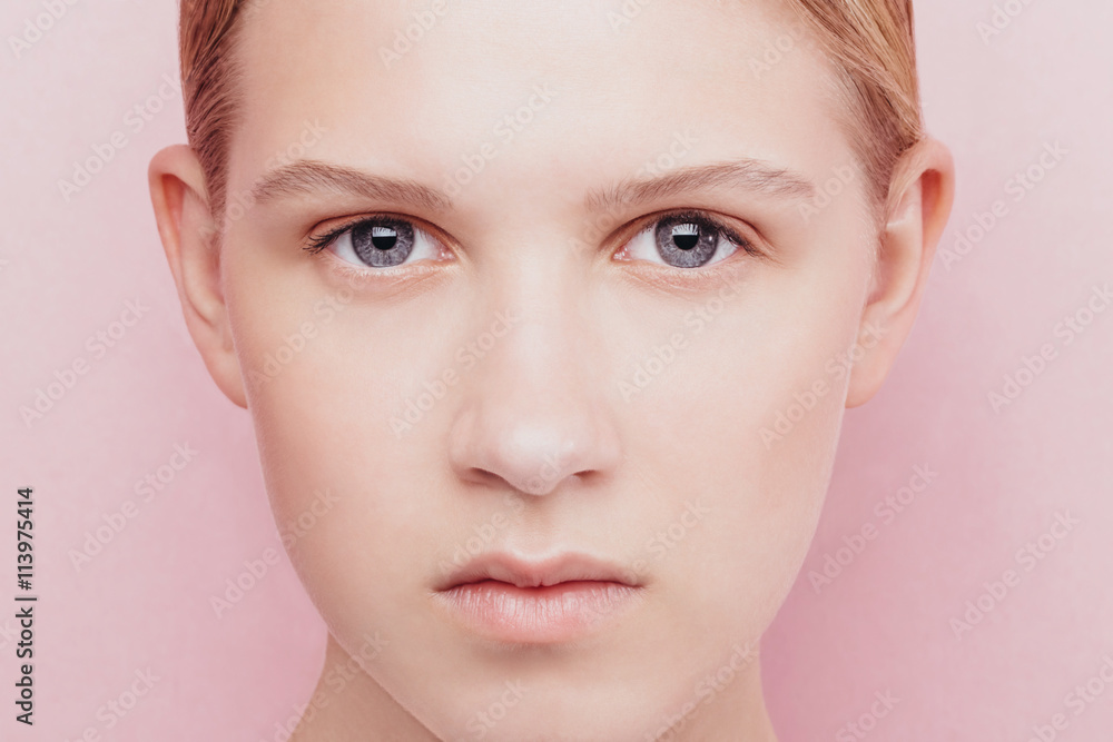 Beauty portrait of a beautiful girl with perfect skin over pink background Beauty portrait of a beautiful girl with perfect skin over pink background