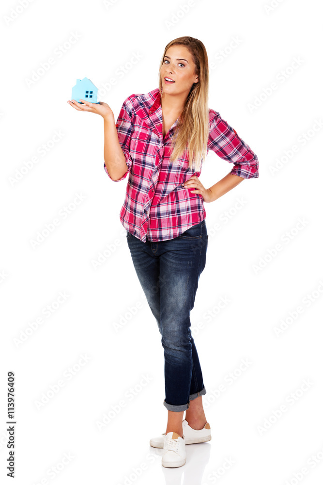 Smililing woman holding a paper house Smililing woman holding a paper house