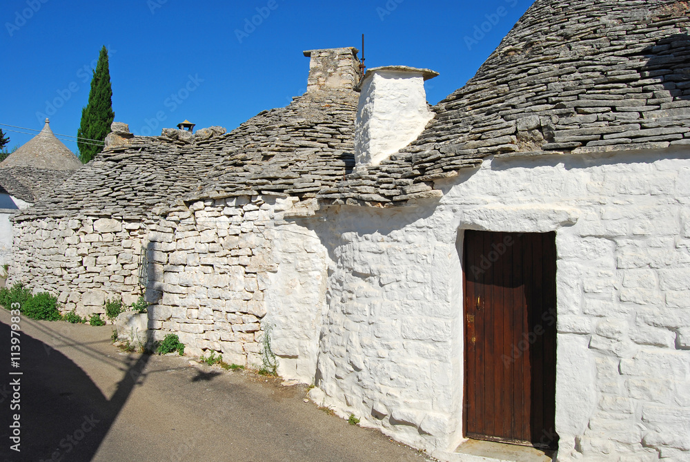 An alley between the characteristic trulli of Alberobello in Apu
