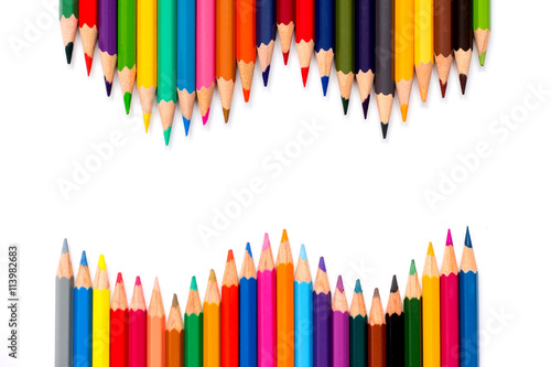 Row of color pencil placed on white background