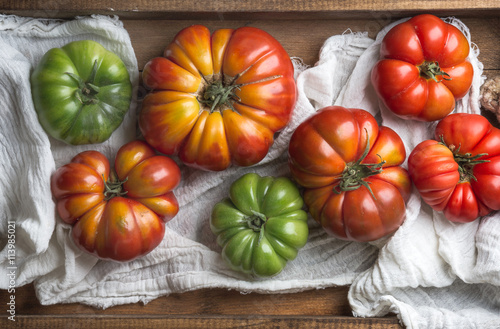 Colorful Heirloom tomatoes in rustic wooden tray