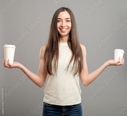 Woman offering white cups of coffee