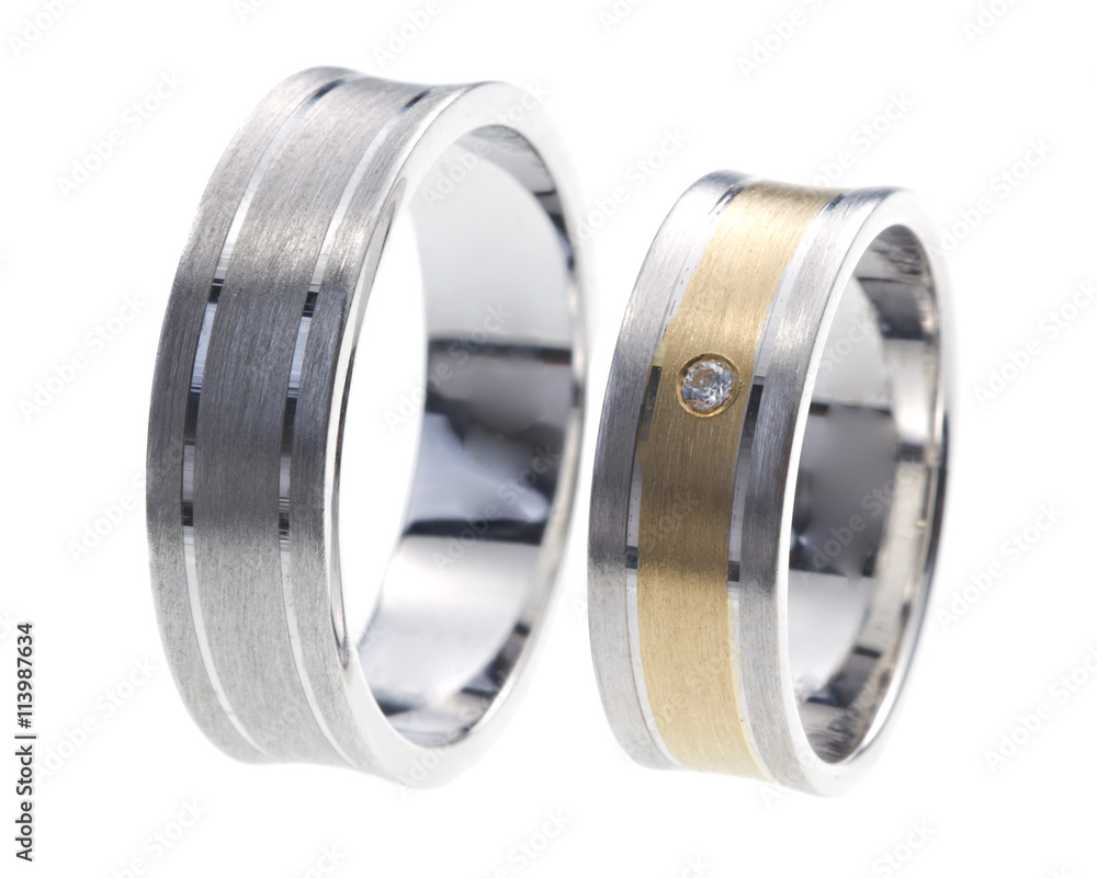 Two rings made of gold and white gold, one with diamond, isolated on white Two rings made of gold and white gold, one with diamond, isolated on white