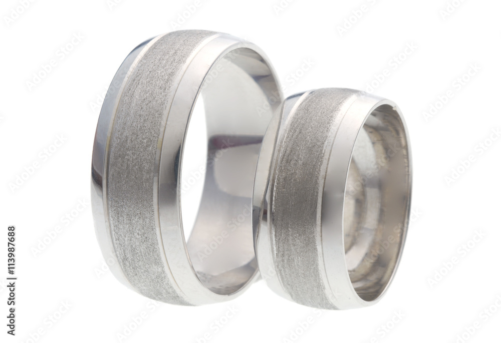 Two wedding rings standing next to each other isolated on white Two wedding rings standing next to each other isolated on white