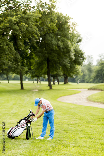 Young man playing golf at the golf court