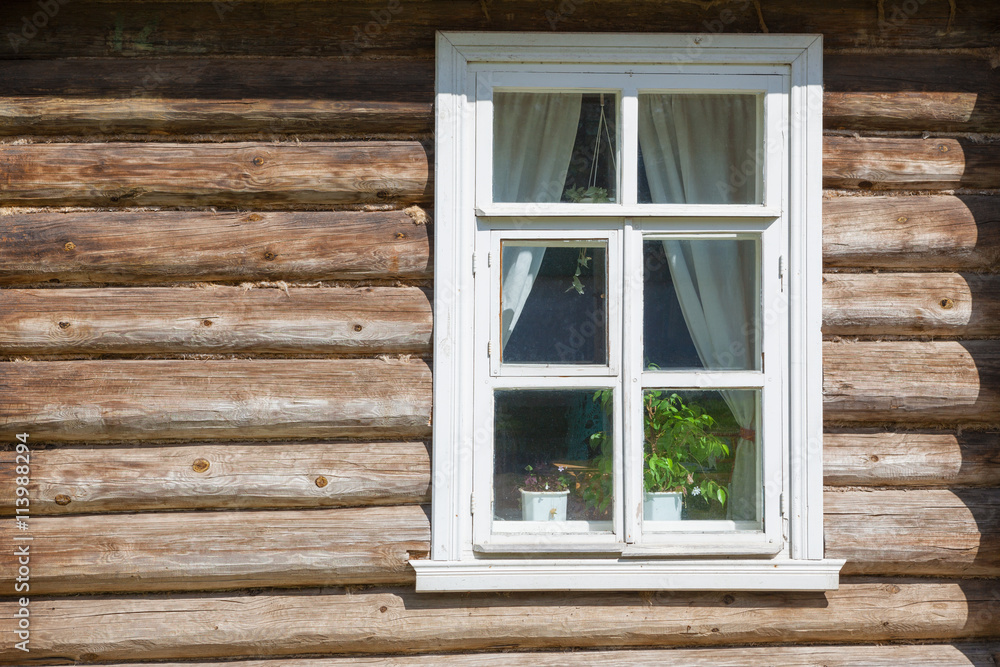 Window on old wooden facade of Russian town Window on old wooden facade of Russian town