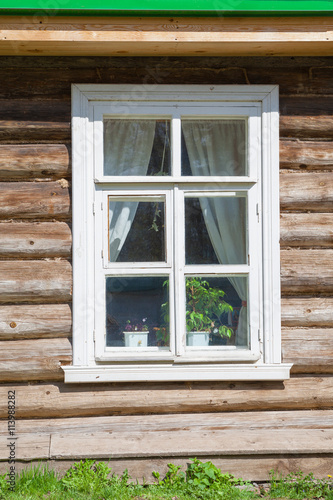 Window on old wooden facade of Russian town