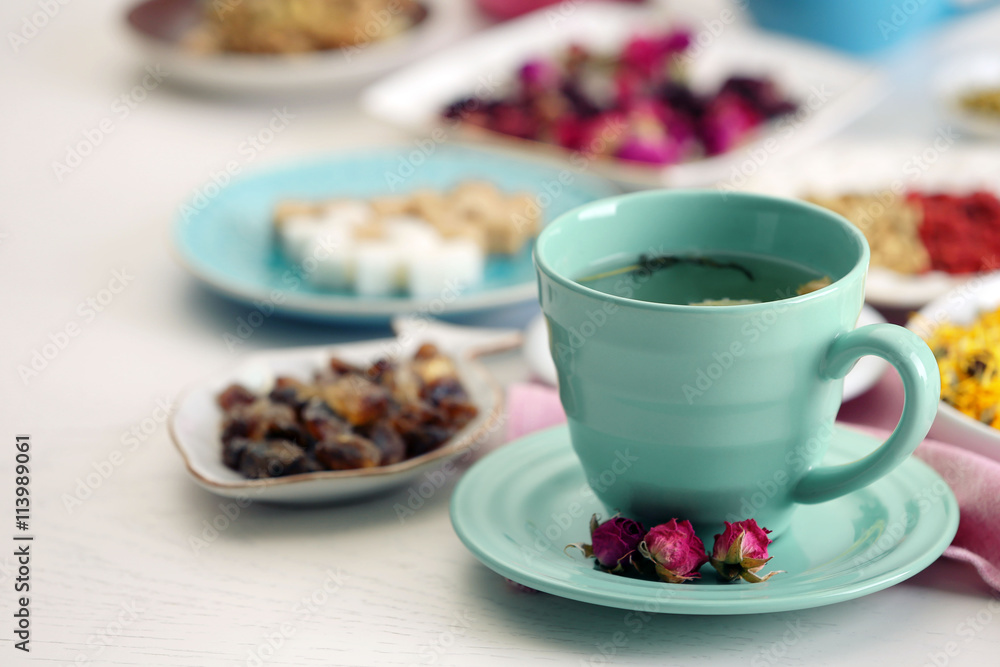 Cup of tea with aromatic dry tea on wooden background Cup of tea with aromatic dry tea on wooden background