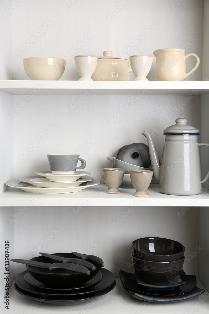 Tableware on shelves in the kitchen cupboard Tableware on shelves in the kitchen cupboard