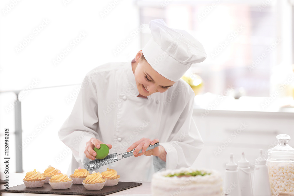 Female chef working at kitchen