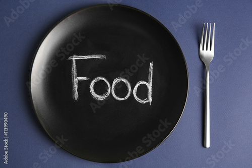 Plate with word FOOD on blue background