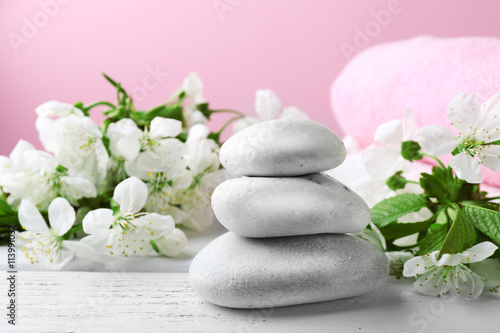 Spa treatment with blooming branch on wooden table