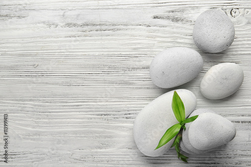 Photography Heap of spa hot stones on white wooden background