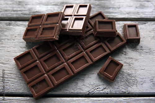 Chocolate pieces on wooden background