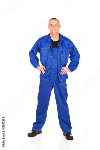 Smiling repairman with hands on hips