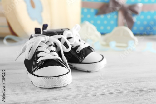 Baby shoes on wooden table