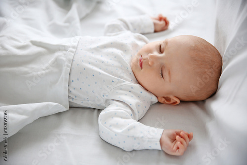 Beautiful sleeping baby in bed