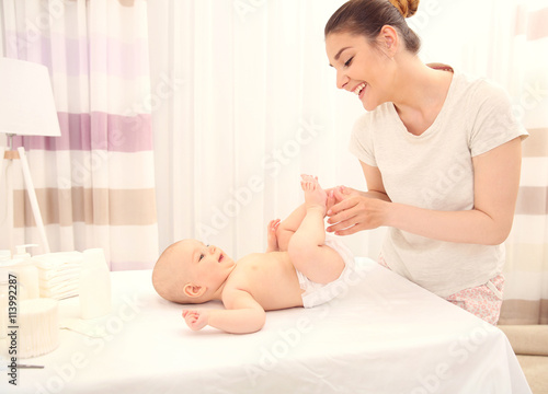 Mother changing diaper to l...