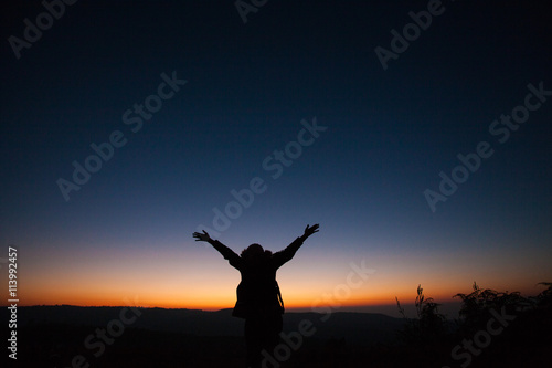 women hug the sky after sunset