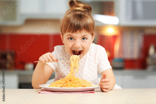 Adorable little girl eating...