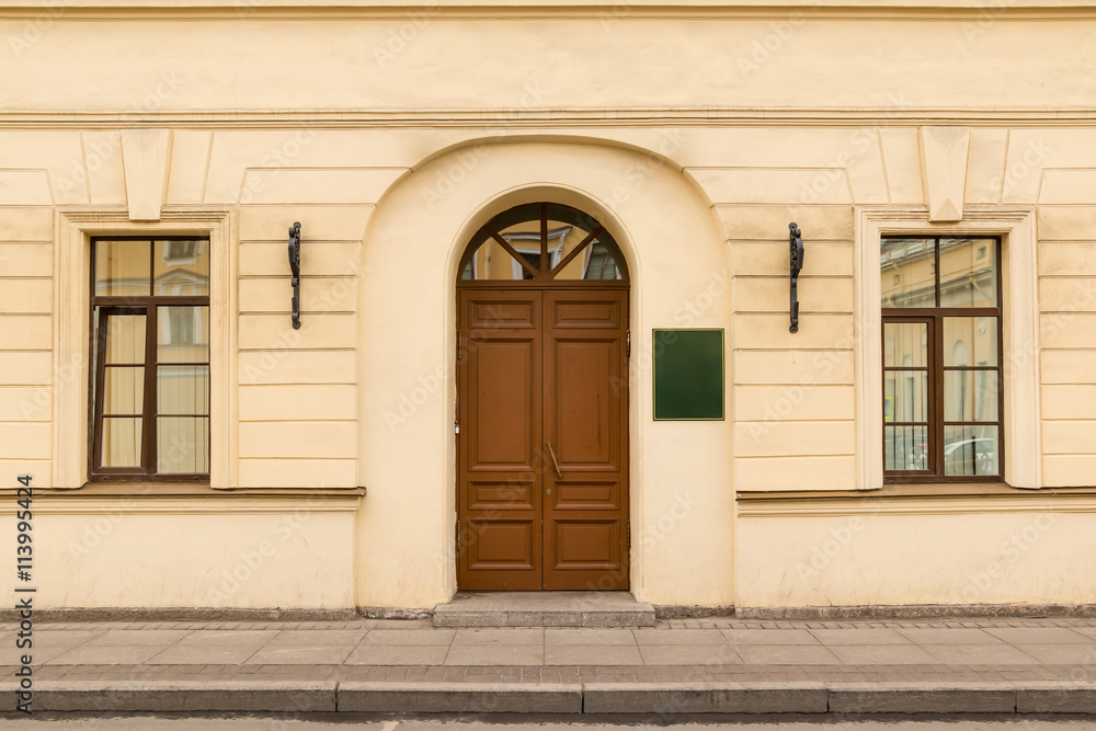 Door and windows on facade of urban office building front view, St. Petersburg, Russia.