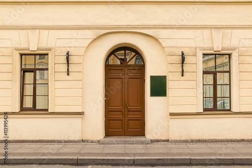 Door and windows on facade of urban office building front view, St. Petersburg, Russia.
