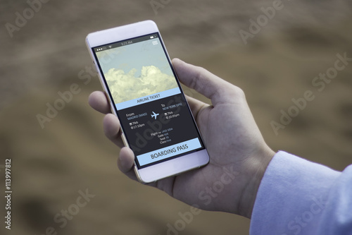 Man using mobile to buy plane ticket