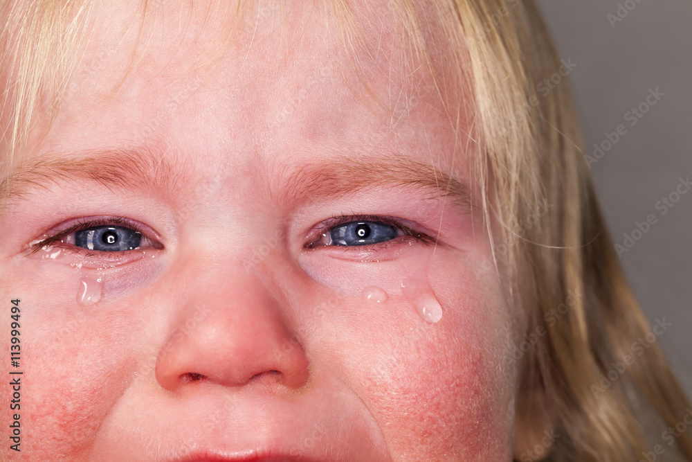 Fototapeta premium portrait of emotional tears crying baby toddler blond long hair