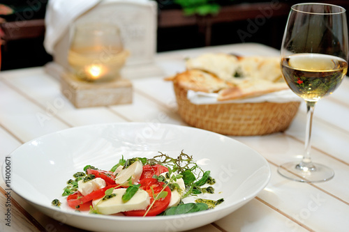 the Italian restaurant menu dish Caprese on the white plate