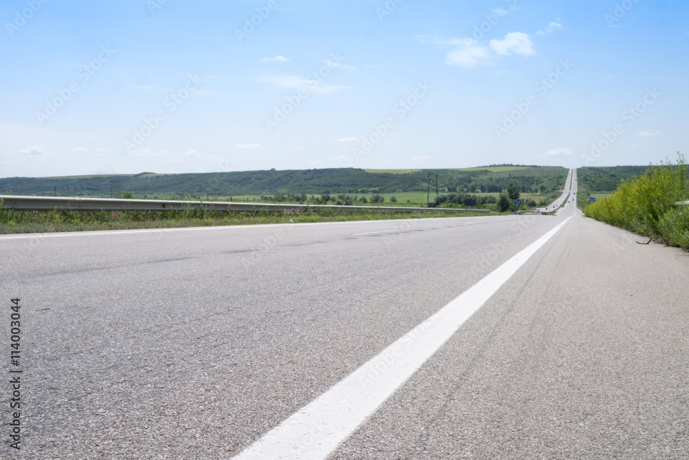 View on the empty road way to horizon in midday summer 