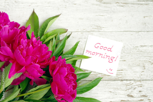 Good morning! Bouquet of pink peonies and the white card with the inscription 