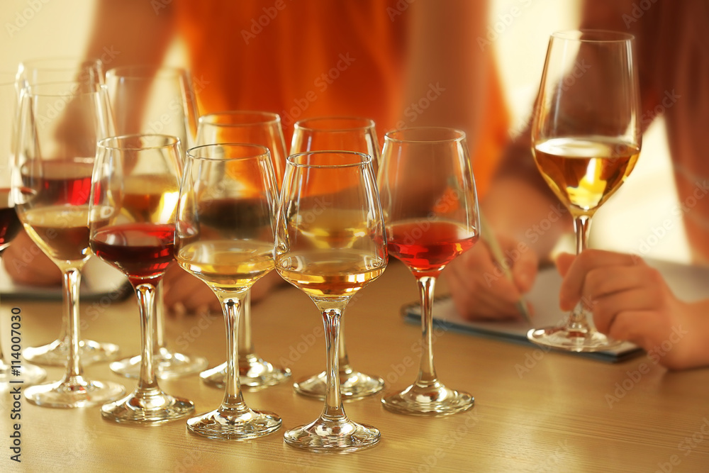 Experts tasting new sorts of wine at the table Experts tasting new sorts of wine at the table