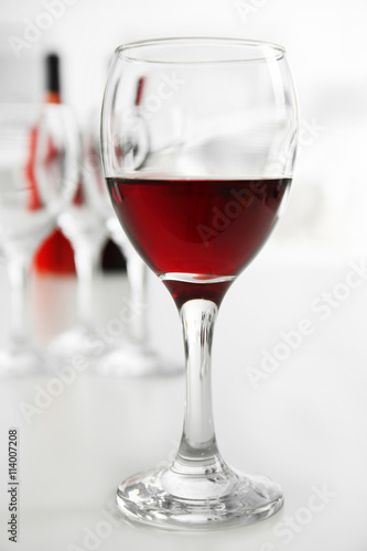 Glasses of red wine on white table closeup